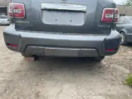 Nissan Armada 2016-2024 Hintere Stoßstange komplett (Original 2019) Foto 1